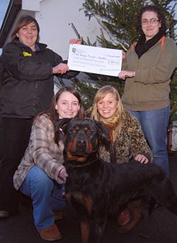 Clockwise from top left, Dogs Trust Roden Manager Louise Campbell, Rebecca Phillips, 22, from Chesterfield, Derbyshire; Kerri Mills, 21, from Solihull and Beth Heayns, 21, from Little Sutton, near Ellesmere Port, with Behr, a young Rottweiler in need of a new home, and the cheque for £825.